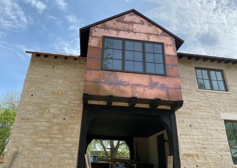 Copper metal panel facade on a stone building for Skylight Installation in Vine Grove